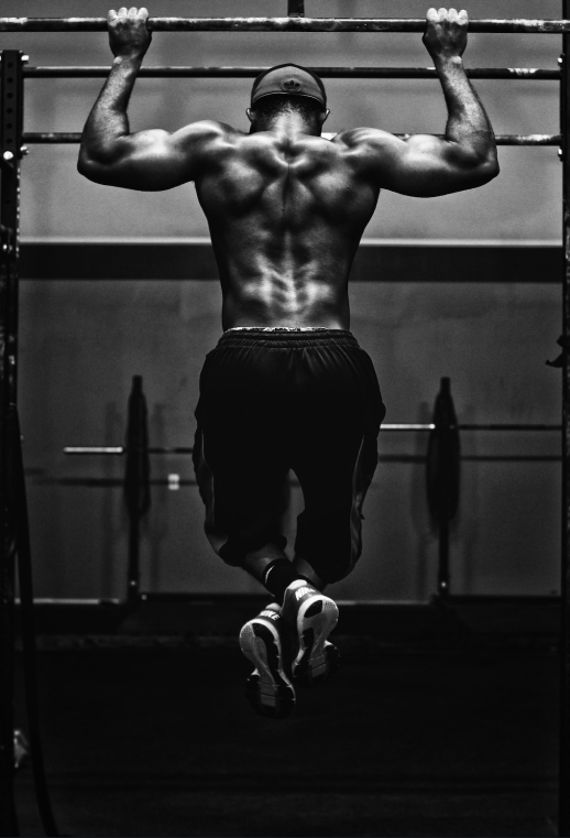 A man pulling himself up a horizontal bar
